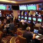 Sports betting excitement at tylekeonhacai88 with patrons placing bets in dynamic casino atmosphere.