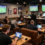 Engaged sports bettors analyzing kèo nhà cái odds while enjoying the game in a vibrant lounge atmosphere.